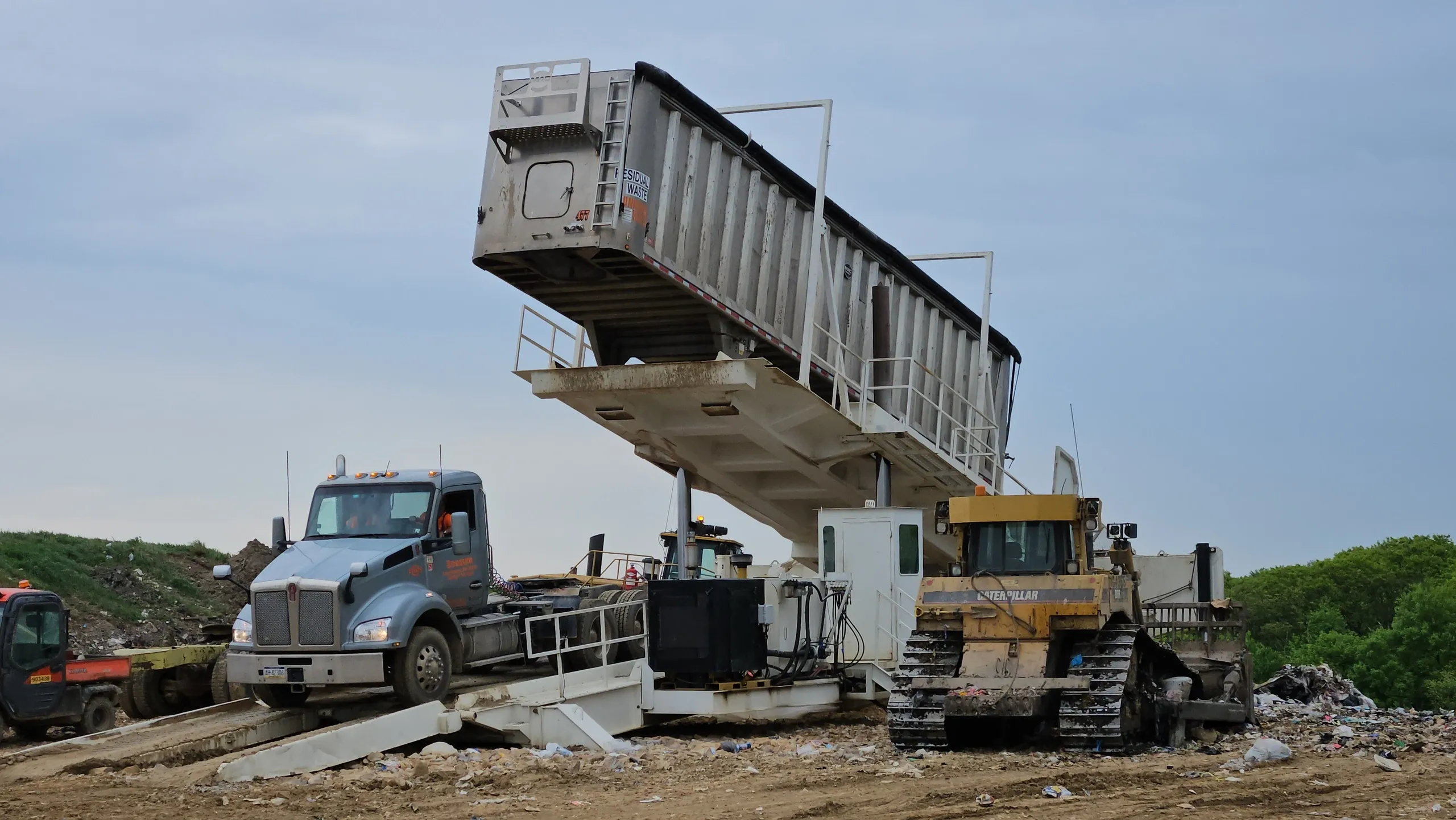 Kenworth and Transfer Trailer Raised on Landfill Hydraulic Tipper